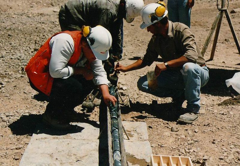 Exploration geologists examining diamond drill core
